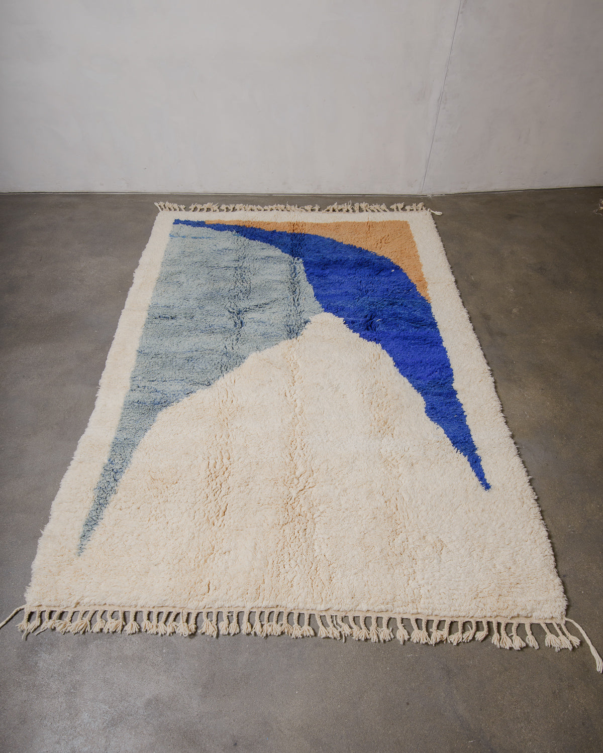 Berberlin Beniourain rug laying on concrete floor.